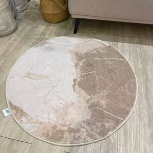 Round polyester carpet with traditional motifs, 0.8m diameter.